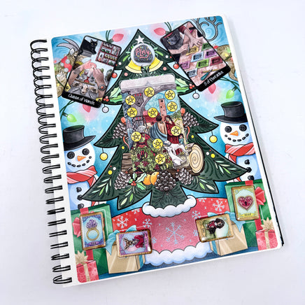 Decorative notebook with Christmas-themed cover featuring a tree, snowmen, and presents on a white background.