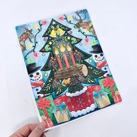 Colorful Christmas-themed notebook with tree, candles, and presents on a white background