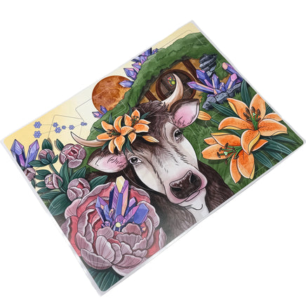 Colorful illustration of a cow with flowers and plants on a white background